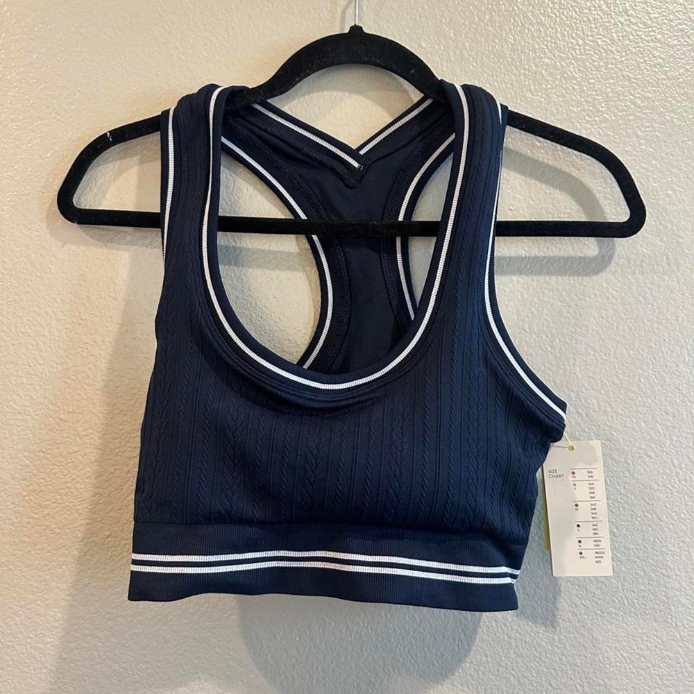 Navy blue sports bra with white trim, size L